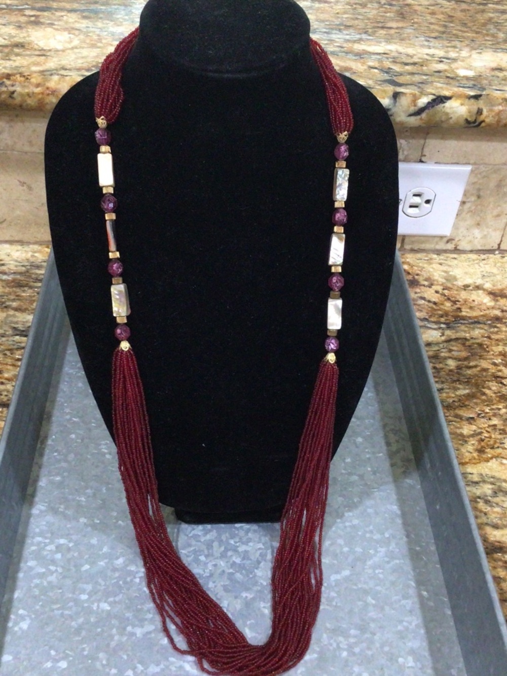 Long burgundy seed beaded necklace. Waterfall design with mother of pearl.